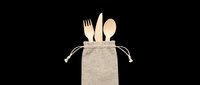 Wooden cutlery set with fork, knife, and spoon in natural linen pouch. Isolated on transparent background, ready for t-shirt designs, clipart, stickers, and print-on-demand products.