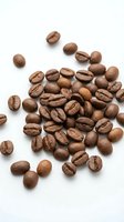 Roasted coffee beans scattered on white background, isolated for cafe branding, packaging design and culinary projects.