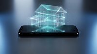 Holographic house model projection from smartphone screen showcasing smart home technology and augmented reality real estate visualization concept.
