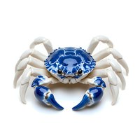 Decorative porcelain crab figurine with blue and white pattern, featuring detailed claws and intricate design on isolated white background for craft and collection display.
