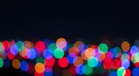 Colorful bokeh lights creating magical atmosphere on dark background for festive celebrations and holiday decorations.
