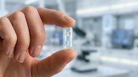 Hand holding small glass vial with clear liquid in modern laboratory setting. Medical research, pharmaceutical testing, scientific analysis concept.