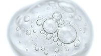 Transparent bubbles and water droplets floating on white background, isolated design element for skincare, cosmetics, and wellness product packaging.