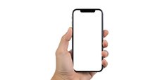 Hand holding modern smartphone with blank white screen isolated on white background for mockup and app presentation design.