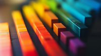Vibrant rainbow colored chalk pastels arranged in diagonal rows creating artistic gradient from warm orange to cool blue tones on dark background.