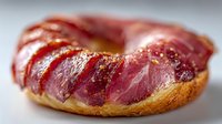 Fresh sliced salami on crusty bread roll creating appetizing deli sandwich with rich red meat and golden crust for food photography and culinary content.