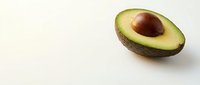 Fresh ripe avocado half with pit removed on clean white background, isolated healthy organic fruit for cooking and nutrition concepts.