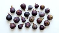 Fresh purple figs arranged on white background, organic Mediterranean fruit collection isolated for culinary design and healthy food concepts.