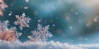 Delicate snowflakes rest on fluffy white snow with sparkling bokeh lights creating magical winter atmosphere for holiday seasonal designs and decorations.