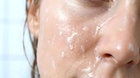 Young woman with fair complexion and wet skin covered in water droplets, displaying skincare, hydration, and freshness concepts for beauty and wellness applications.