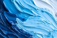 Abstract fluid art background with swirling blue and white paint strokes creating dynamic wave-like patterns and textures. Macro photography of acrylic paint.