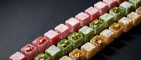Colorful Turkish delight lokum candy cubes arranged in rows with nuts and flavors on dark background for gourmet dessert and confectionery designs.