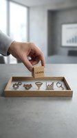 Businessman hand placing wooden block with leads text above tray containing business icons representing sales funnel and lead generation process.