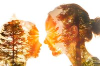 Double exposure profile of young Asian woman combined with pine forest silhouette at golden sunset, showing connection between human and nature in warm tones.