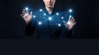 Young businessman manipulating glowing network connections with hands, representing digital transformation and connectivity solutions for modern business.
