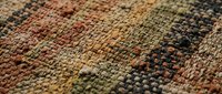 Woven textile fabric with multicolored threads showing detailed texture and craftsmanship for interior design and home decor projects.