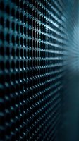 Close-up of dark blue metallic mesh grid with shallow depth of field creating abstract pattern for technology or security concepts.