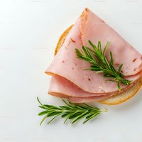 Sliced ham sandwich with fresh rosemary on white wooden background, appetizing deli meat open-faced toast for breakfast or lunch.