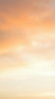 Soft gradient sky transitioning from warm peachy orange tones at top to pale cream and white at bottom, creating serene atmosphere suitable for backgrounds and design projects.