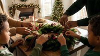 African American family decorating a festive Christmas wreath together at home, holiday tradition with children, cozy winter interior with tree lights.
