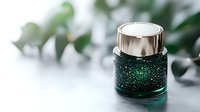 Luxurious green glitter cosmetic jar with metallic silver cap on white background, soft focus eucalyptus leaves decoration for beauty product photography.