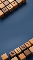 Buy and rent words spelled with wooden blocks on blue background, representing real estate, property management, housing market, and rental business concepts for websites and marketing materials.