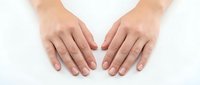 Female hands with natural manicure displaying open palms gesture on white background, isolated for skincare and beauty product design concepts.