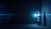Male doctor in white coat holding glowing digital network sphere with connected dots and light rays in futuristic blue environment for medical technology concepts.
