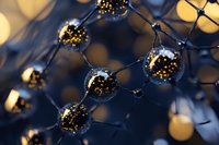 Glowing golden spheres connected by dark lines create futuristic molecular structure against blurred bokeh background, suggesting scientific innovation and technology.
