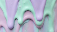 Pastel mint, lavender and pink cream texture dripping smoothly, creating a soft abstract background for beauty, cosmetic or food design.