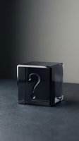 Black transparent cube with white question mark symbol on dark surface representing mystery, uncertainty, and unknown concepts for business presentations.