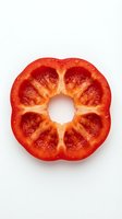 Red bell pepper cross-section isolated on white background, showing fresh produce interior chambers and seeds. Suitable for food, nutrition, cooking, and healthy eating design projects.
