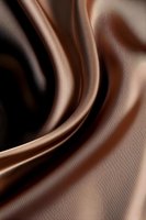 Smooth flowing curves of liquid chocolate create elegant swirls and waves against dark background, abstract luxury design for confectionery and dessert marketing.