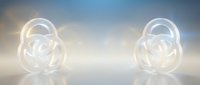 Glowing white abstract spheres with interlocking rings emit soft light against a blurred neutral background, suitable for technology, innovation, and futuristic design projects.