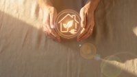 Hands protecting glowing house icon with heart symbol representing home insurance, real estate protection, family security and property care concept.