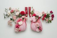 Human lungs decorated with pink and red flowers on white background, symbolizing respiratory health, nature, and wellness in medical art.
