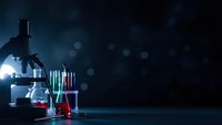 Laboratory microscope with colorful test tubes and beakers on dark background with bokeh lights for scientific research and medical analysis.