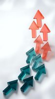 Colorful glass arrows pointing upward in coral and teal colors representing growth, success, progress and business development on white background.