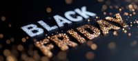 Glittering text Black Friday with sparkling gold and silver particles on dark background, festive bokeh lights create magical shopping atmosphere.