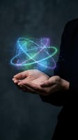 Businessman hands holding glowing atomic structure hologram with neon orbits representing science technology innovation and digital transformation concepts.