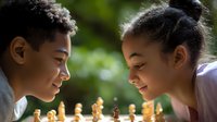 Young African American boy and mixed race girl playing chess outdoors, focused on wooden chess pieces during friendly match on sunny day. Natural learning environment.