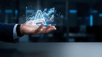 Businessman hand holding glowing financial growth charts and upward arrows, representing stock market analysis, investment success, and digital business analytics.
