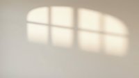 Soft window shadows cast on neutral beige wall, creating geometric light patterns for interior design, architecture, and minimalist backgrounds.