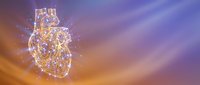 Glowing anatomical heart with golden light particles and energy streams against purple sunset sky background for medical and spiritual concepts.