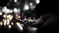 Glowing digital audio wave on smartphone screen with bokeh lights in dark background, hands holding mobile device displaying sound visualization.