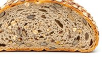 Artisan multigrain bread slice showing swirled texture with seeds and grains, perfect for bakery menus, healthy eating concepts, and food photography.