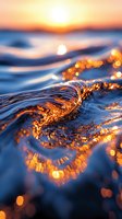 Ocean wave catching golden sunset light creating magical sparkles and reflections on water surface during dusk, macro photography perspective.