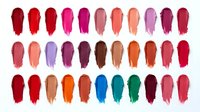 Colorful lipstick swatches collection displaying vibrant makeup palette with diverse shades from red to pink, orange, purple, blue and green tones.
