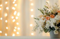 Elegant floral arrangement with peach roses and white flowers in vase against soft bokeh light background, creating romantic atmosphere for weddings or celebrations.