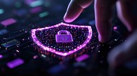 Glowing pink cybersecurity shield with padlock icon on dark keyboard background illustrates digital protection and network safety concept for business security.